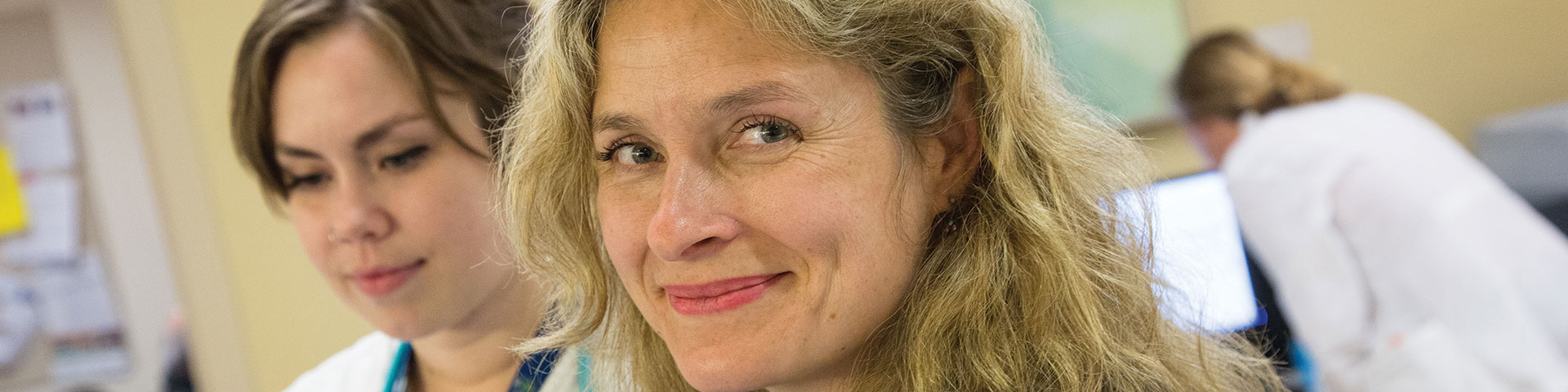 Three women at work in a health care setting