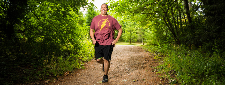 Winter Rhodes running along a trail in a forest
