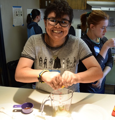 A young woman squeezes lemons over a measuring cup