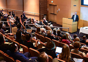 An audience viewing a presentation at a conference.