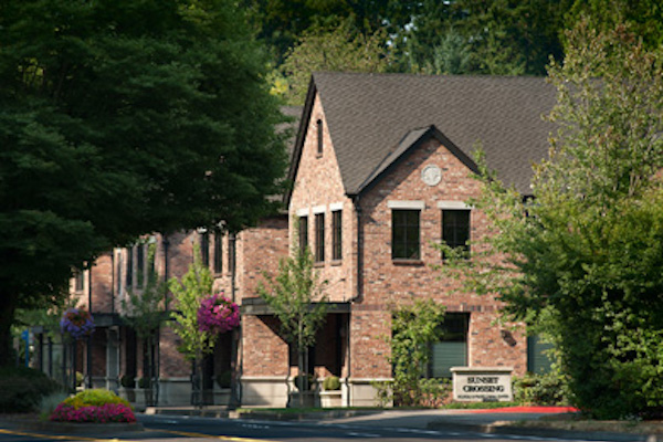 Brick building surrounded by trees.