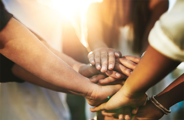Women stacking hands together
