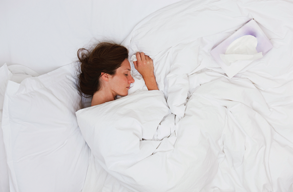 woman in bed with tissues