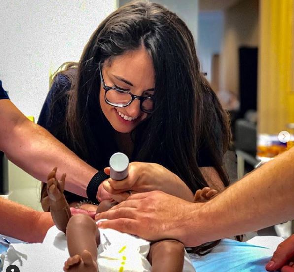 Female resident intubates a mannequin infant