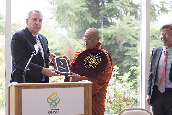 OHSU President Dr. Joe Robertson, Sayadaw from Tipitaka Hospital in Myanmar and Casey's Dr. Dave Wilson sign a memorandum of understanding.