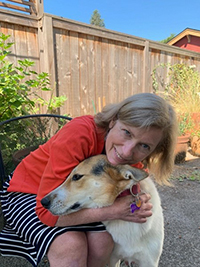 Dr. Melissa Weddle hugging her dog outside.