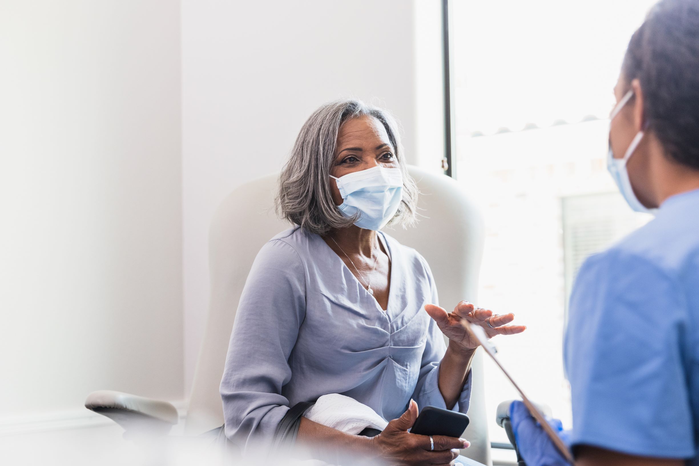 Woman in her 60s talks with health care provider.