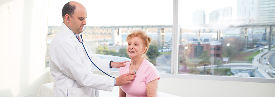 Dr. Cetnar uses a stethoscope during a clinic visit.