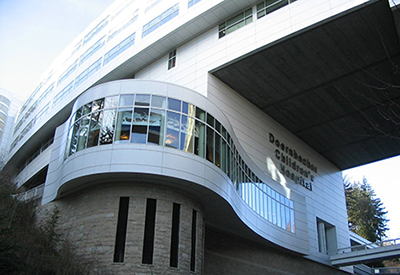 An exterior photo looking up at OHSU Doernbecher Children's Hospital from the street below.