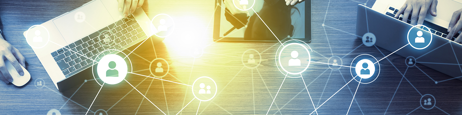 Laptops and ipads connected by icon graphics. Image courtesy of Getty Images