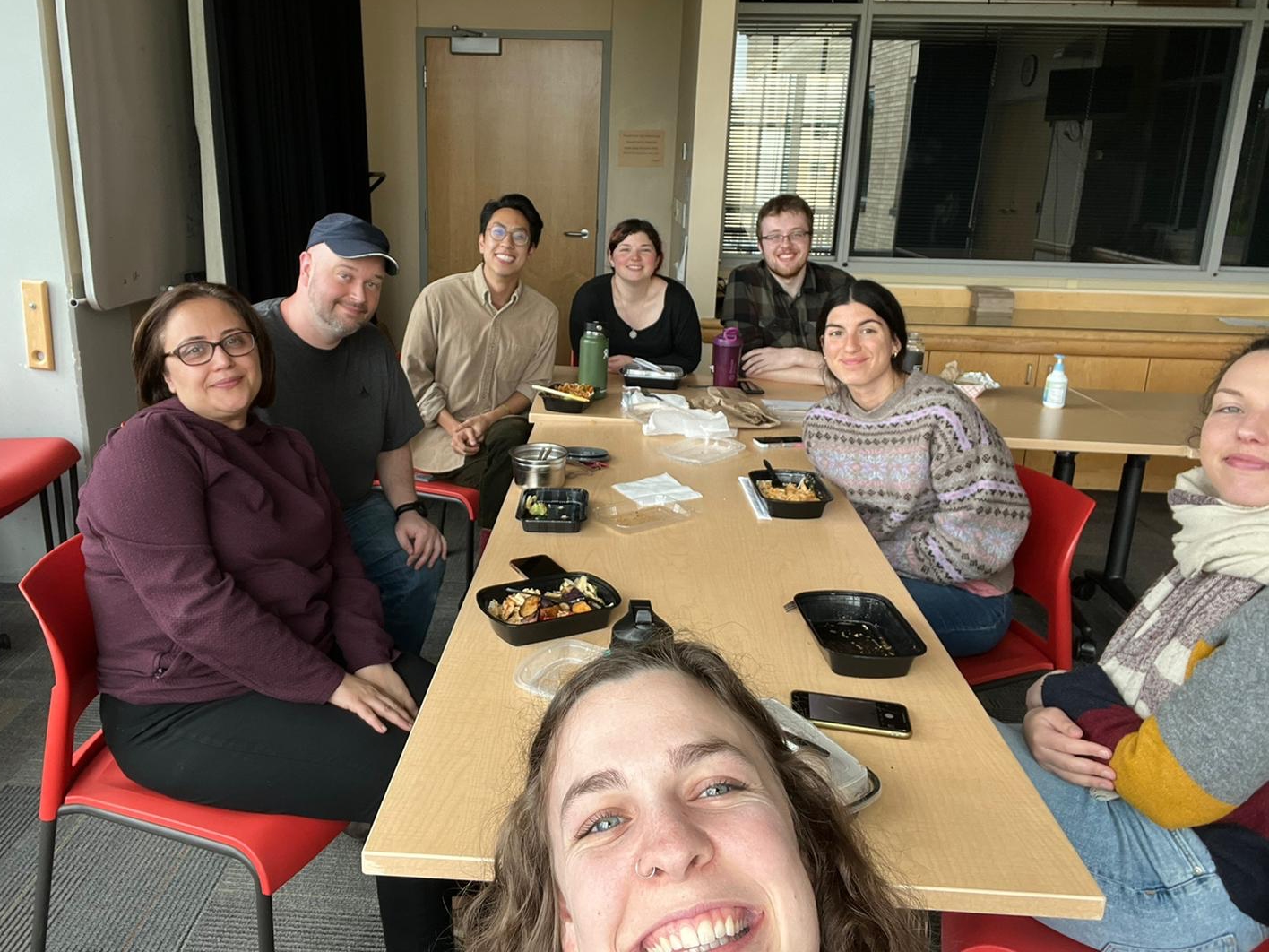 Ajami Lab members seated around a table