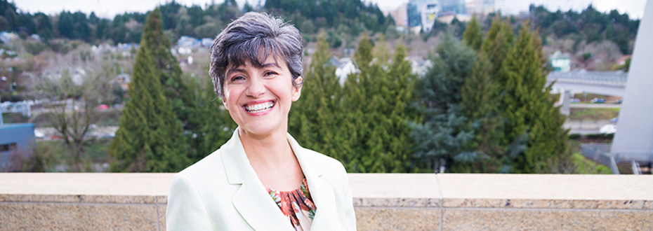 Maria Fleseriu, M.D., FACE in white coat with OHSU Portland behind her