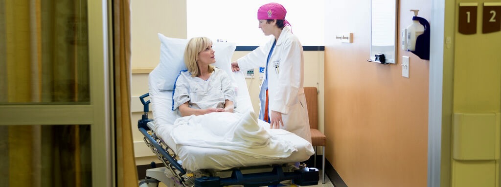 OHSU breast cancer surgeon Dr. Hansen visits with a patient in clinic.