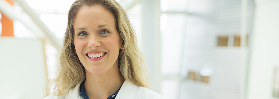 Photo of Dr. Andrea Stroud at OHSU in white lab coat