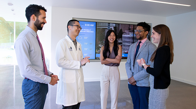 Residency Program Director Dr. Dan Tu stands with four residents at OHSU.