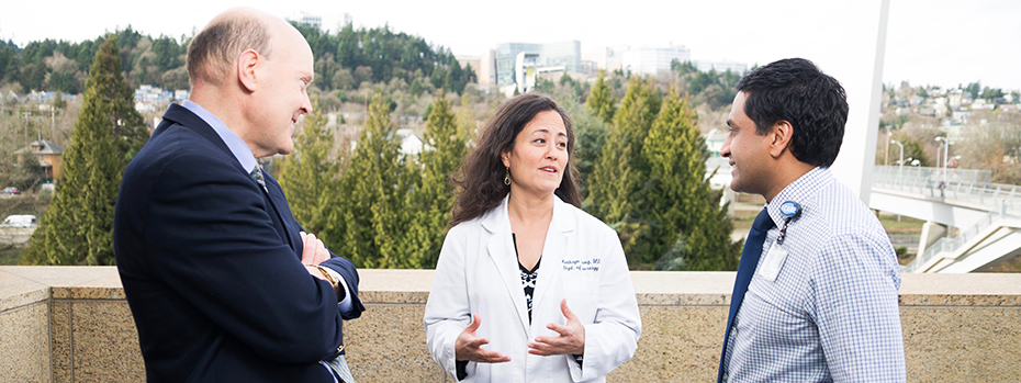 Dr. Joseph Quinn, Dr. Kathryn Chung and Dr. Vivek Unni having an outdoor meeting at OHSU