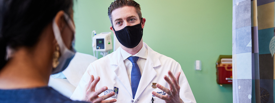 Dr. Robert Eil talking with a patient.