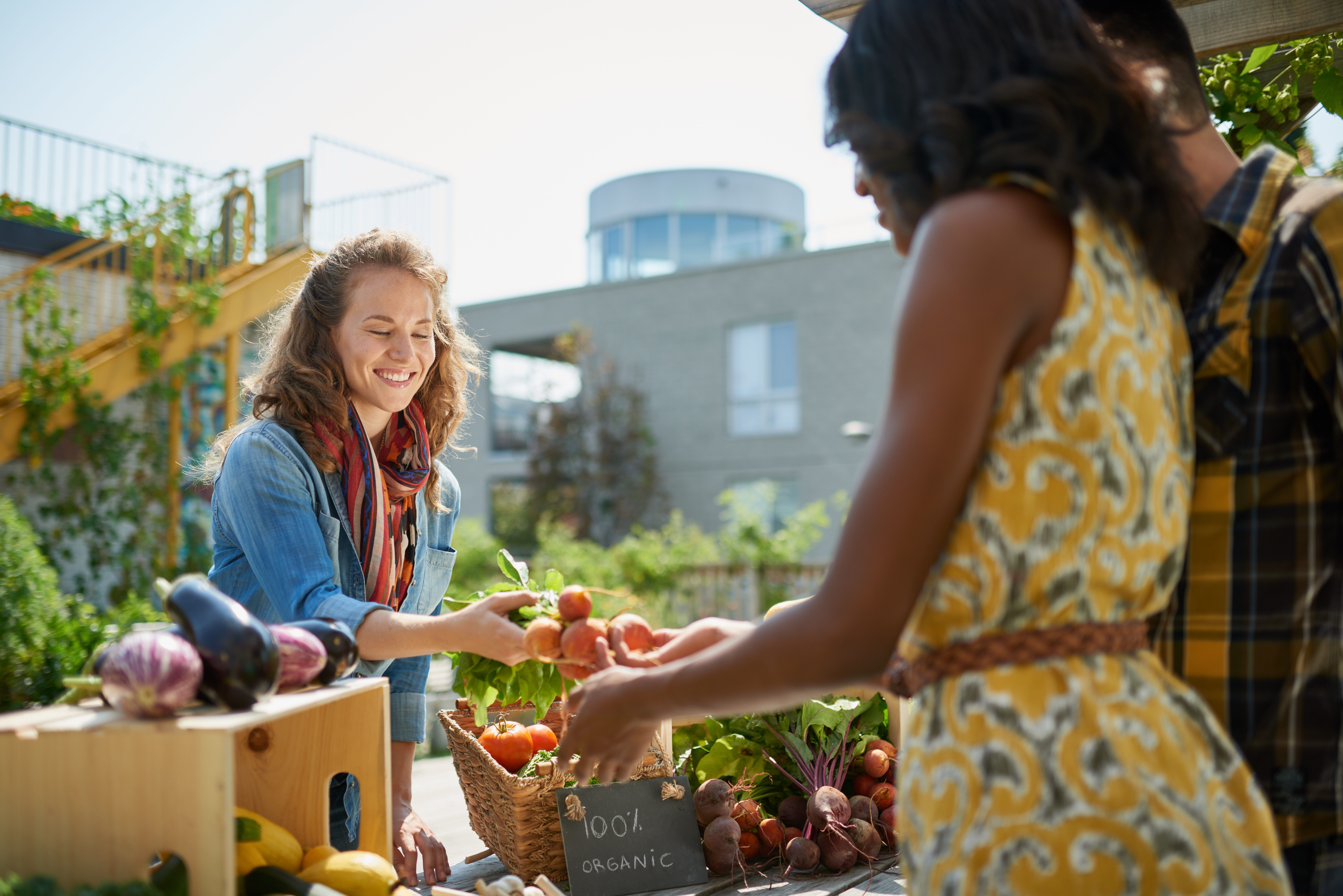 people interacting at the farmers market
