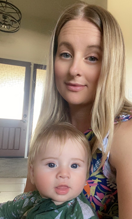 A woman holds a baby on her lap.
