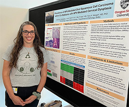 Morgan lab personnel standing next to presentation board