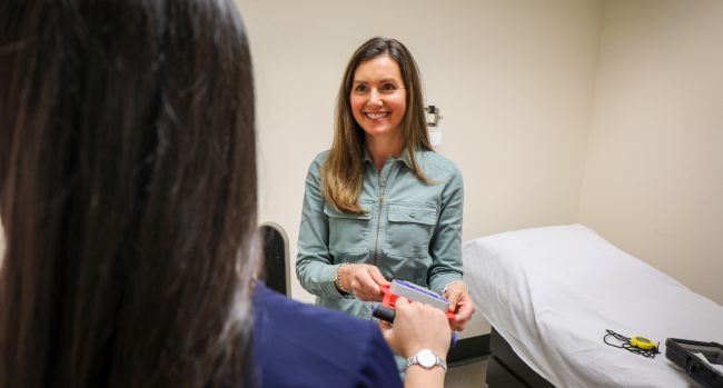 OHSU School of Nursing faculty member Quin Denfeld works with a patient