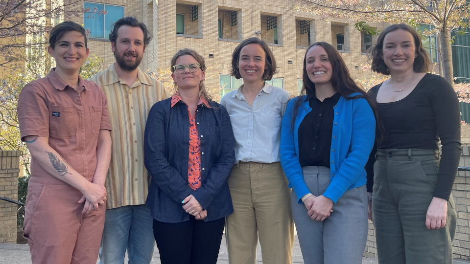 group of 7 Ph.D. students lined up for the camera