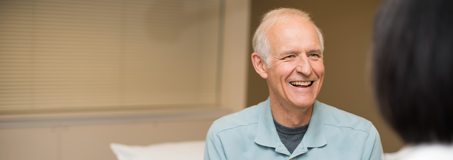 A patient smiles as he chats with OHSU vascular surgeon Dr. Enjae Jung.