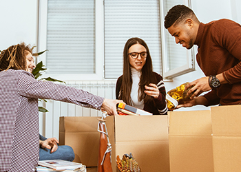 Students unpacking in their apartment.
