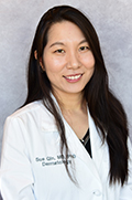 Sue Qin, M.D., Ph.D. smiles for a portrait