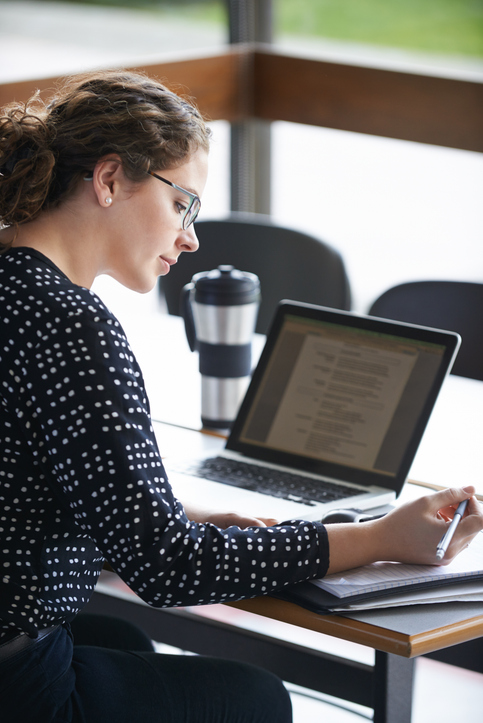Cropped shot of an attractive young woman studying in the university library
