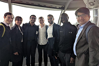 A group of residents in formal attire riding the OHSU Tram.