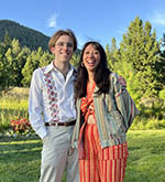 Photo of Bram Rickett and a friend or partner outside with mountains in the background.
