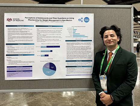J. Vasquez in front of presentation poster