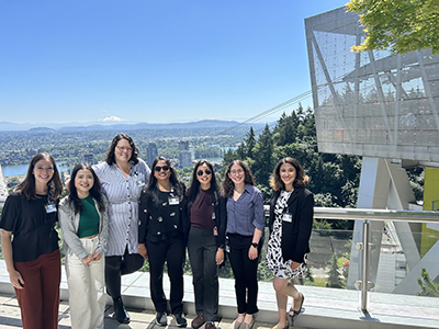 Residents posing in front of the tram and mount hood