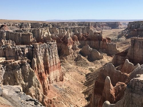 A landscape showing a dry canyon with rocky plateaus on either side.