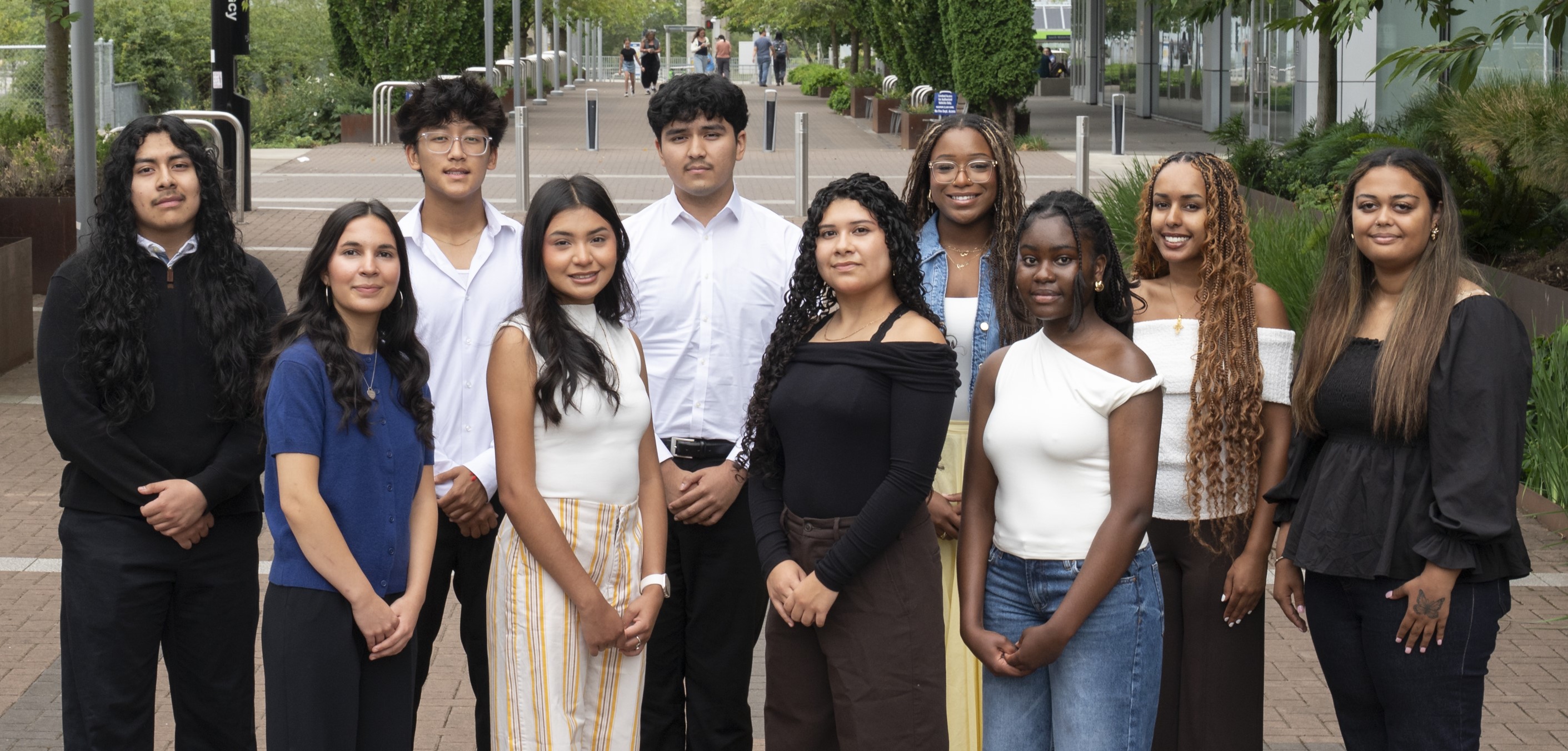 Ten CURE Program interns standing outside of the Knight Cancer Research Building in August 2025.
