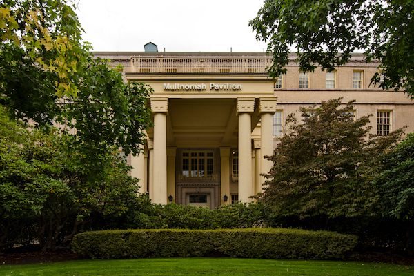 Building with columns surrounded by greenery 
